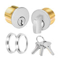 Mortise lock cylinder with oval silver face, brass body, includes keys and key ring.