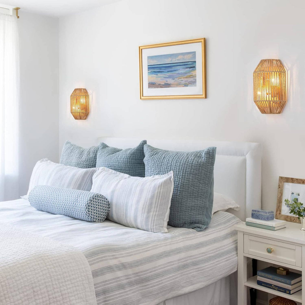 Two woven rattan wall sconces with warm light shining through the wicker lattice