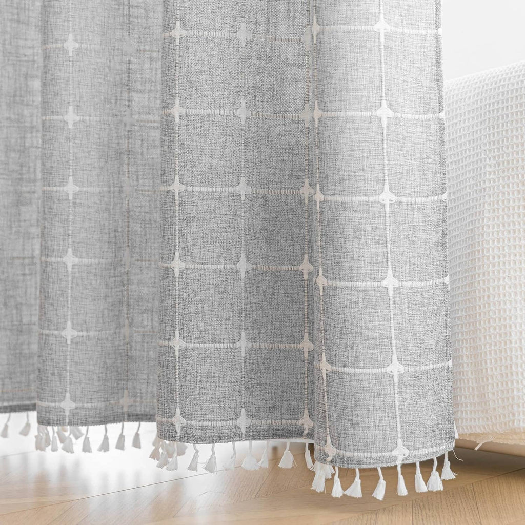 Bottom hem with fringe tassels on a grey and white shower curtain