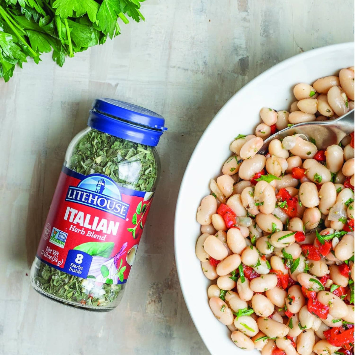 Litehouse Italian herb blend jar with dried green herbs and blue lid