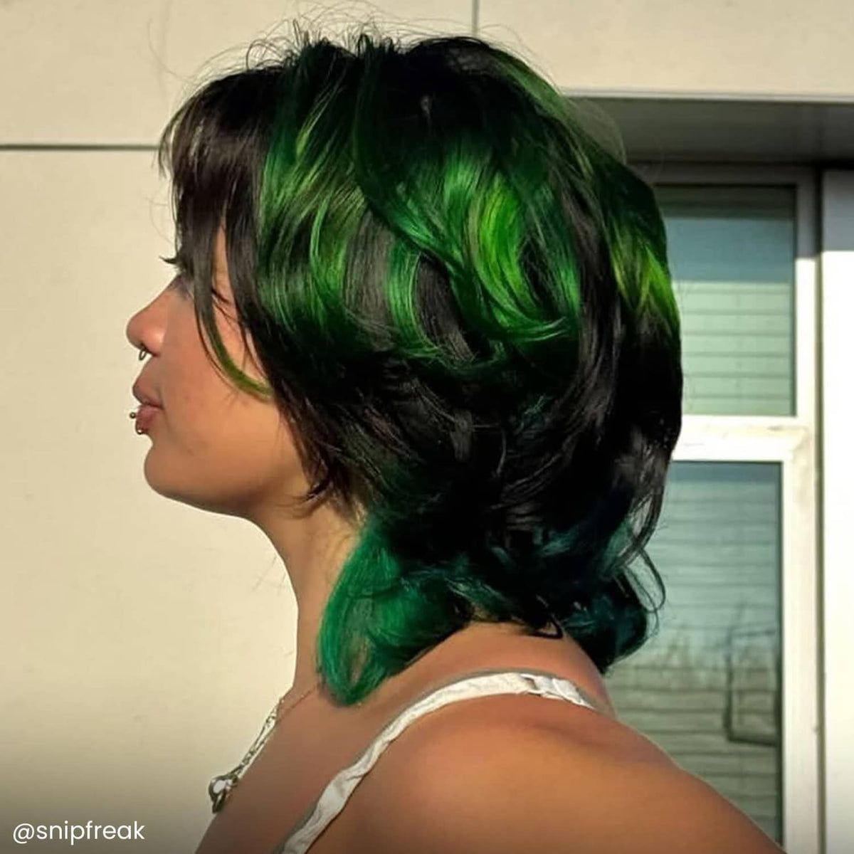 Semi-permanent Phantom Green hair color on short hair with green highlights