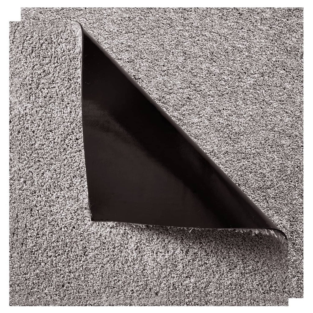 Close-up of carpet tile corner showing dark backing underside