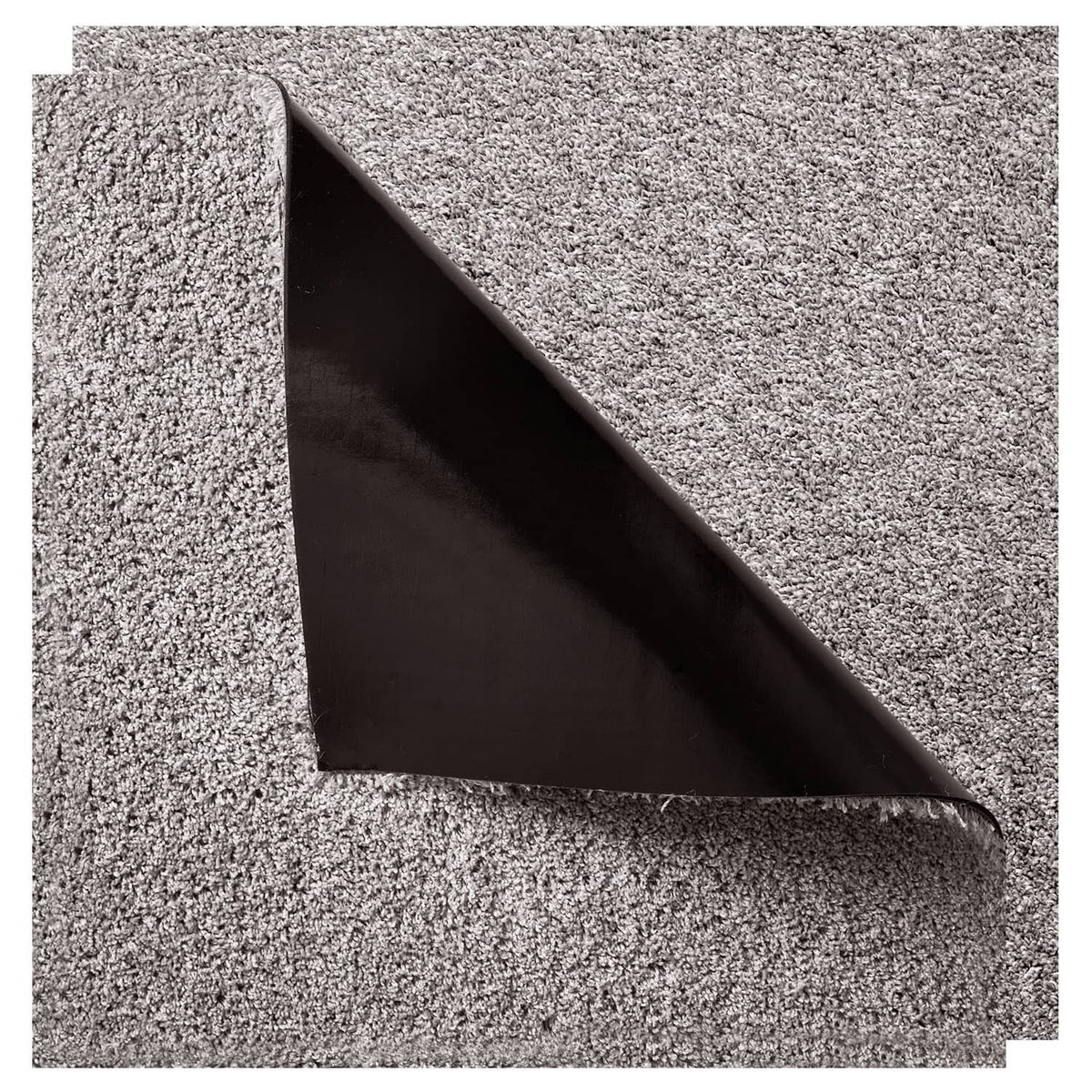 Close-up of carpet tile corner showing dark backing underside