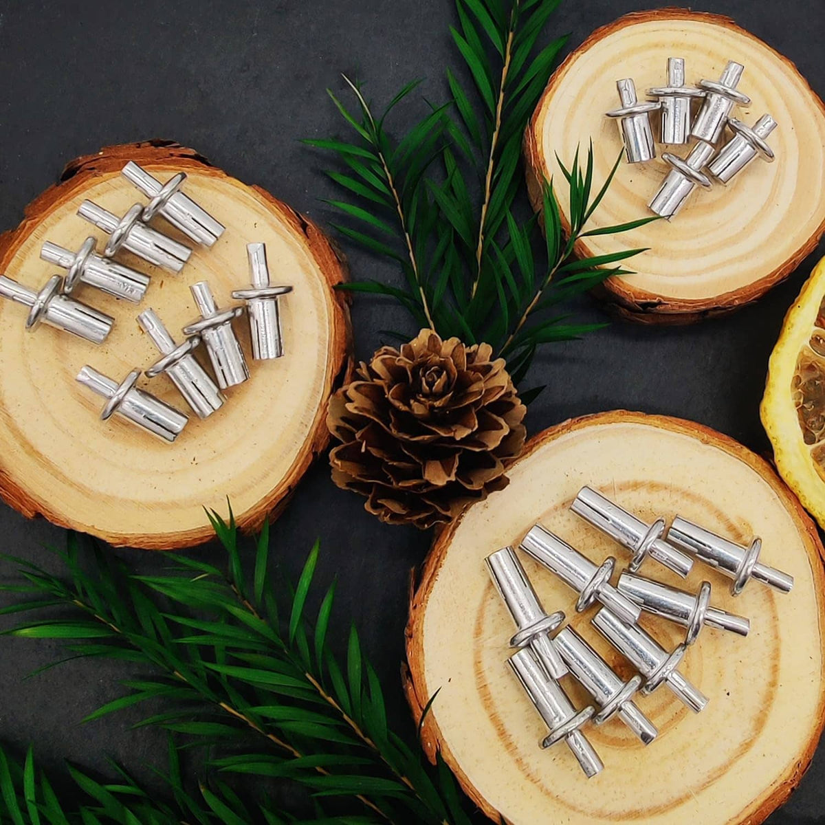 Aluminum hammer drive rivets with round heads arranged on cut wood slices