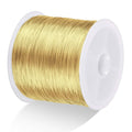 Gold-toned 26-gauge jewelry wire spool, copper coil wound on white plastic reel