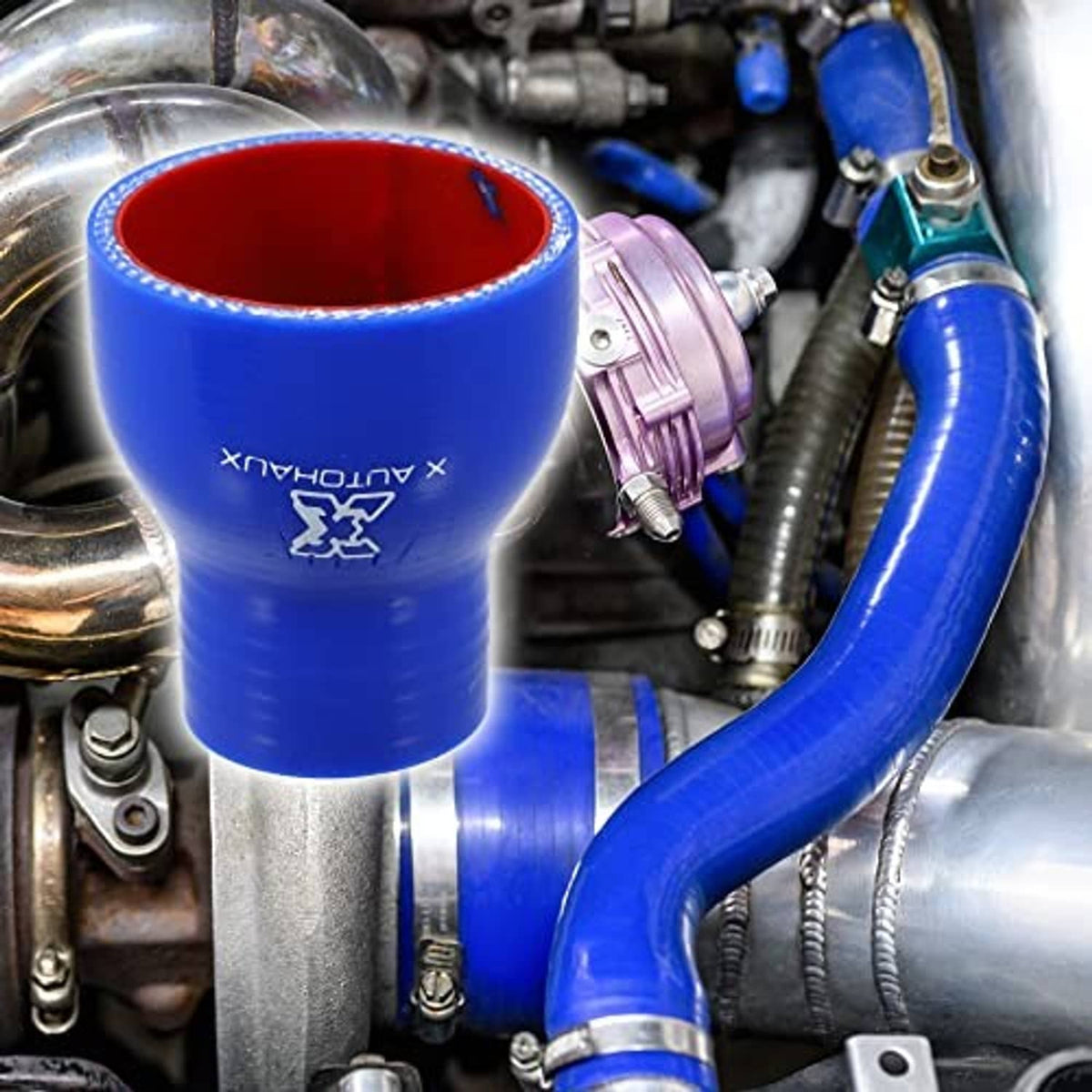 Blue silicone reducer hose coupler installed in engine bay with red-lined opening