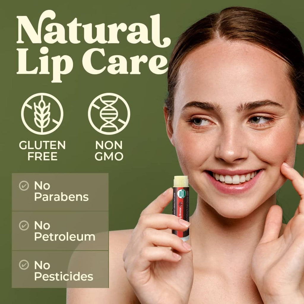 Smiling woman holding an organic lip balm tube near her lips