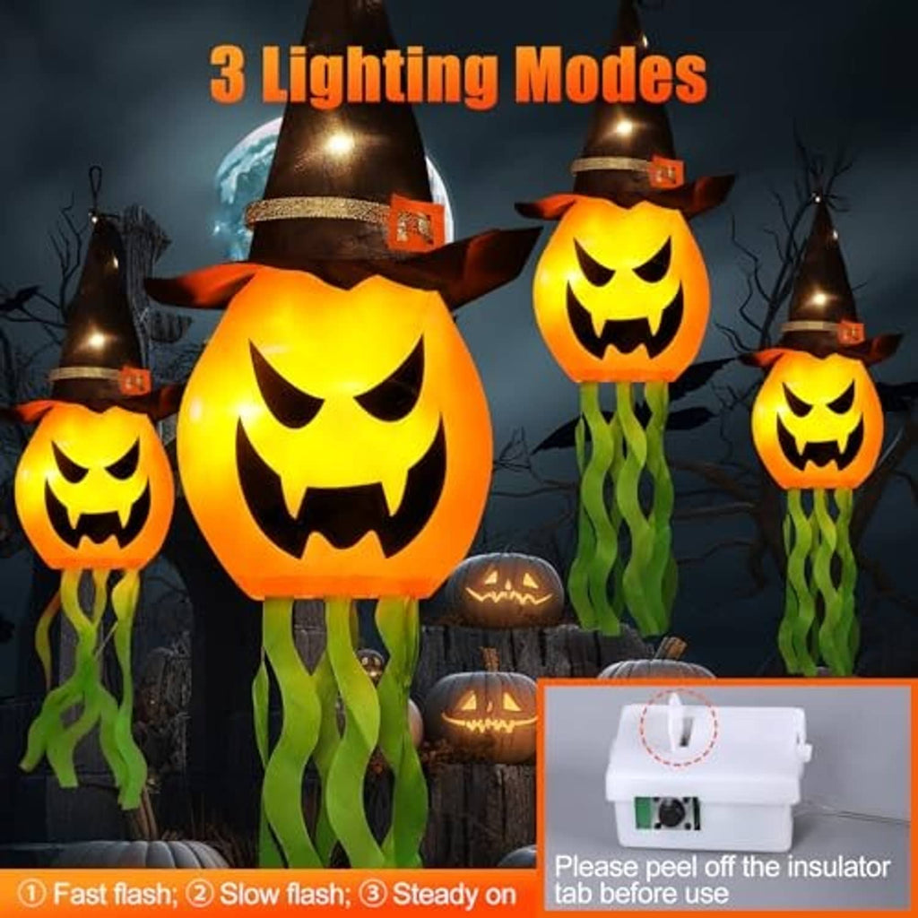 Glowing jack-o’-lantern hanging lights with black witch hats and green tentacle streamers
