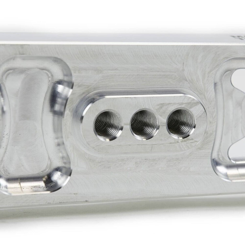 Close-up of silver mounting plate with three threaded bolt holes