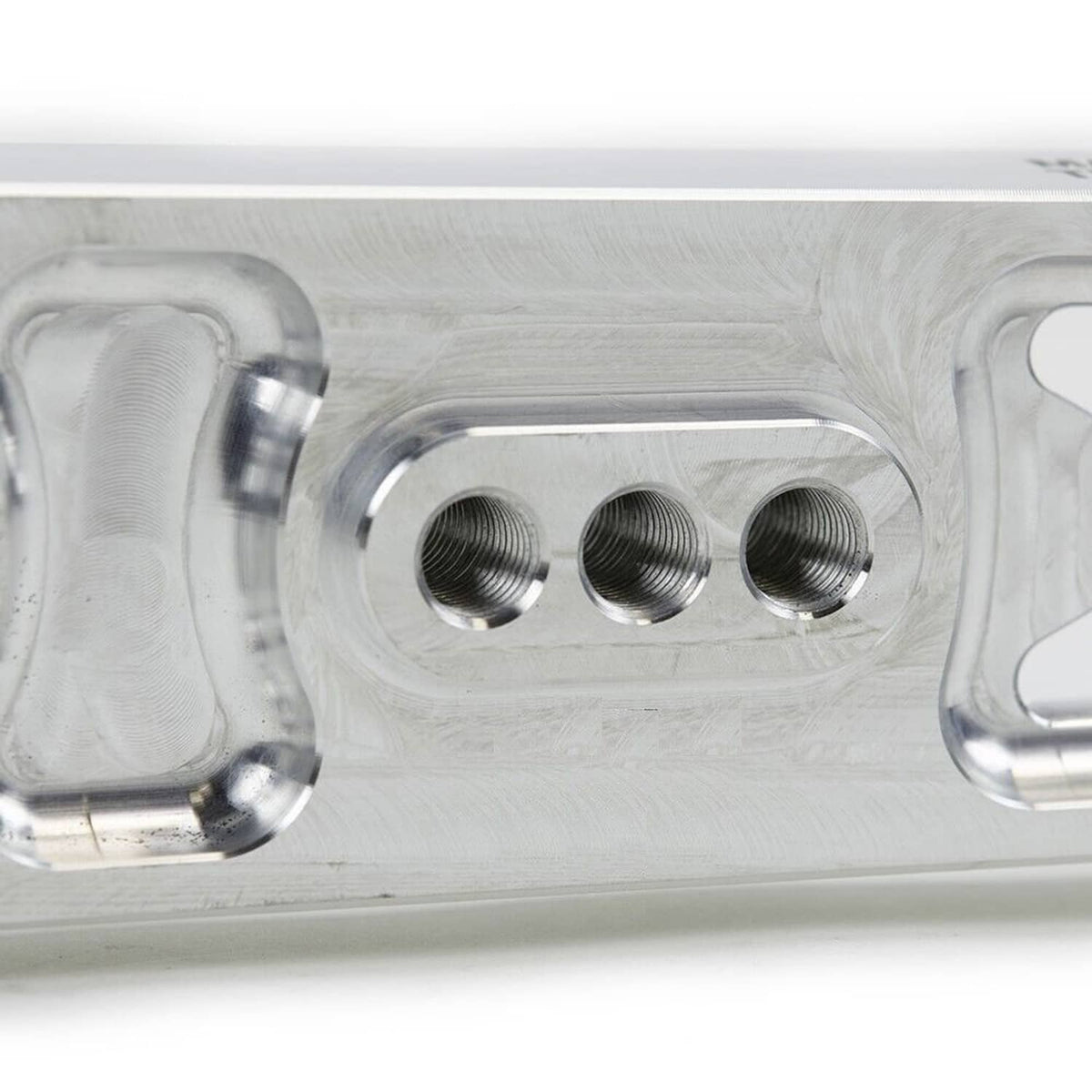 Close-up of silver mounting plate with three threaded bolt holes