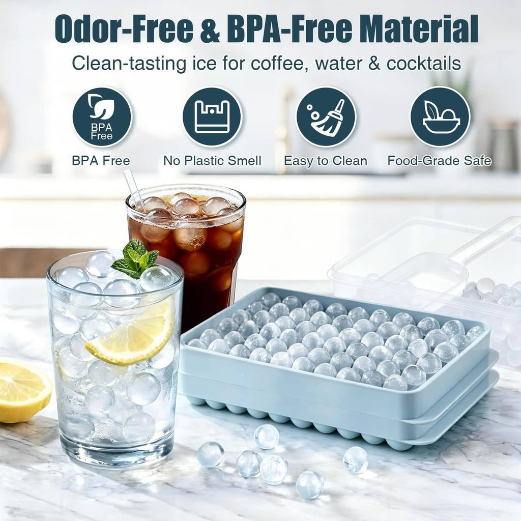 Blue mini ice ball tray filled with clear ice balls beside glasses
