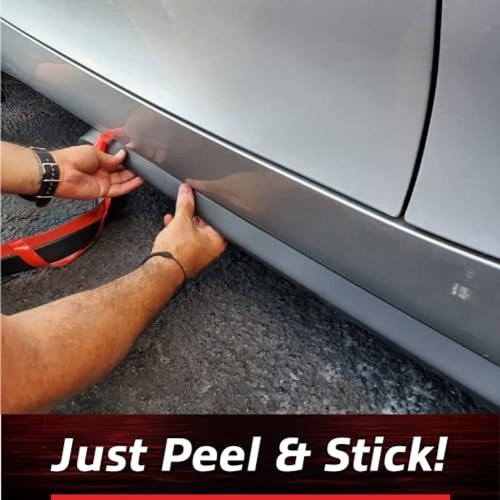 Adhesive lip spoiler trim being applied along a car rocker panel edge with smoothing hand