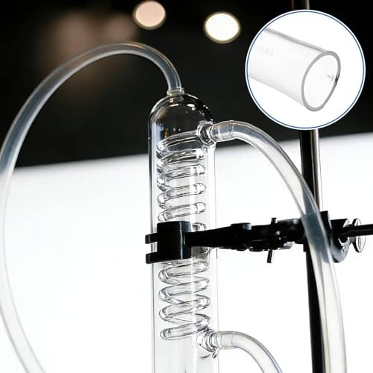 Clear flexible vinyl tubing connected to a pump outlet, with coiled hose section.