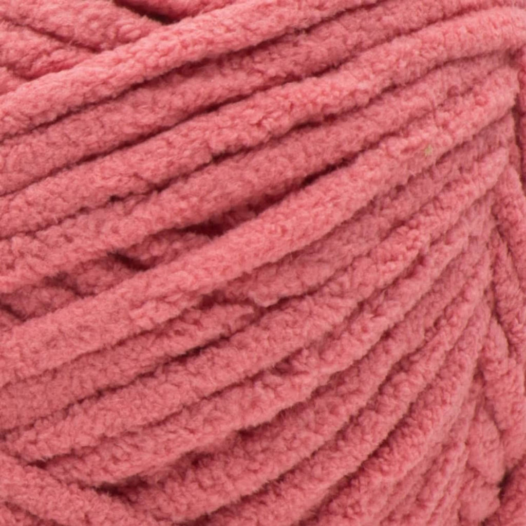 Close-up of chunky terracotta rose pink yarn with thick braided strands
