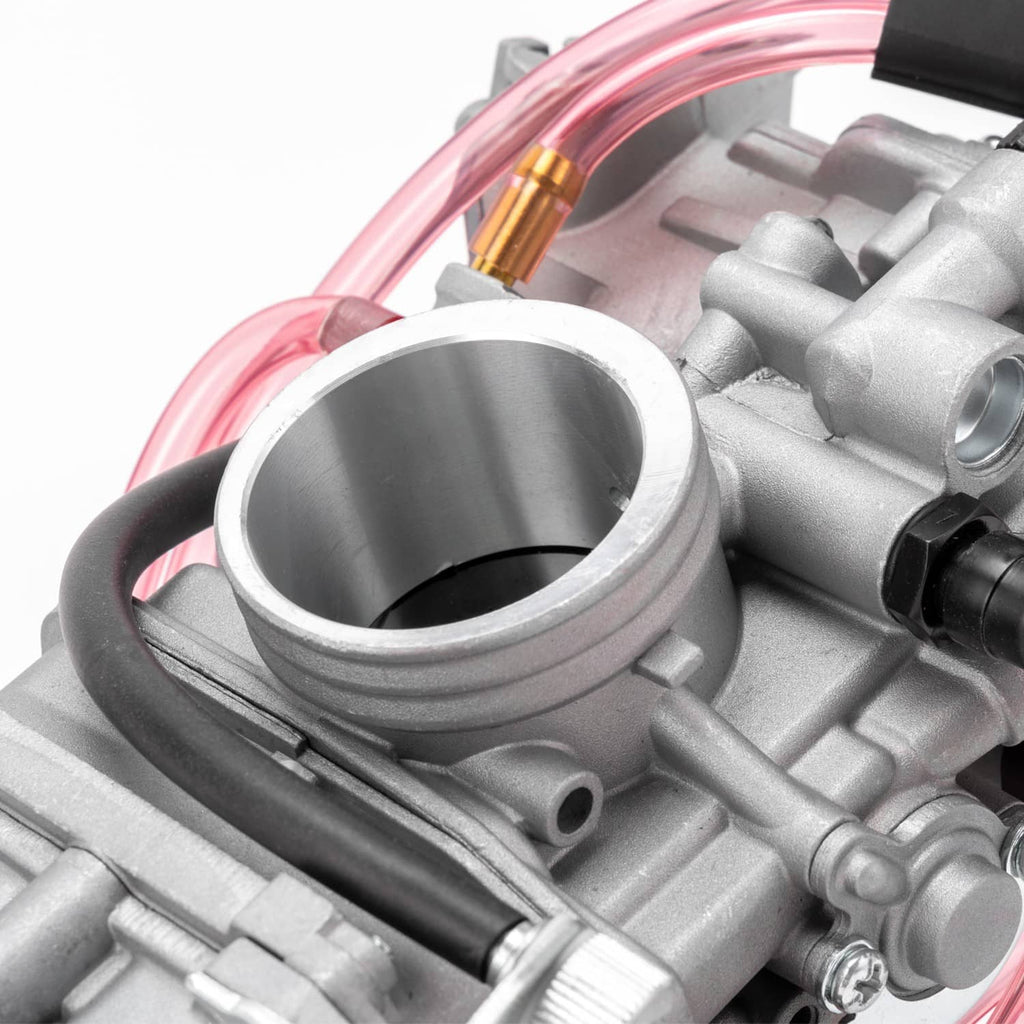 Close-up of carburetor intake and float area on gray body with pink fuel lines
