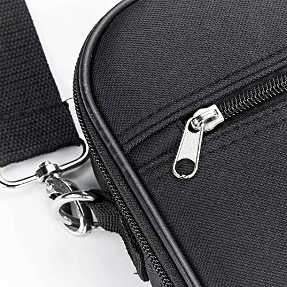 Black fabric case corner with metal zipper pull and snap hooks for carrying