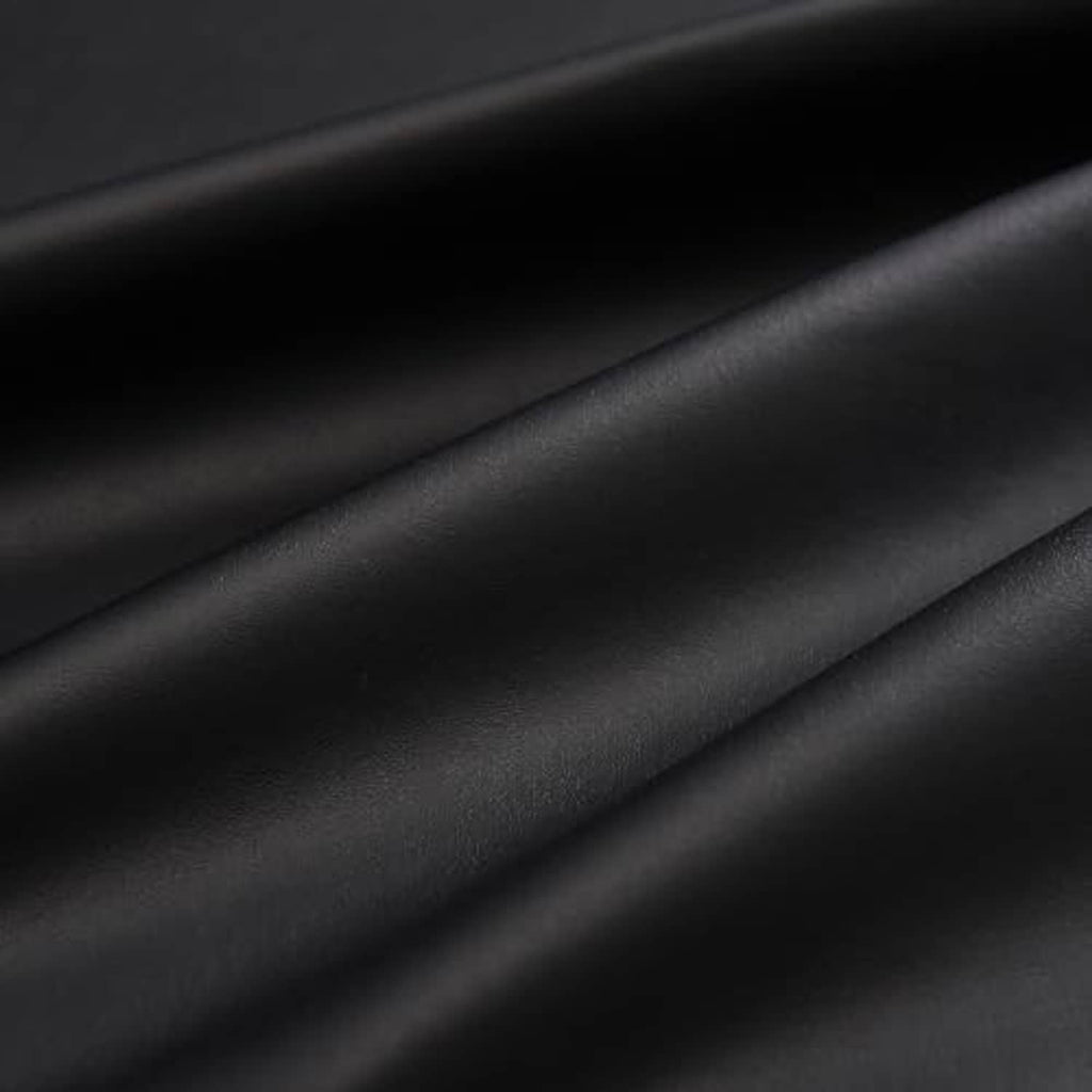 Close-up of black PU vinyl leather texture with smooth, matte surface grain
