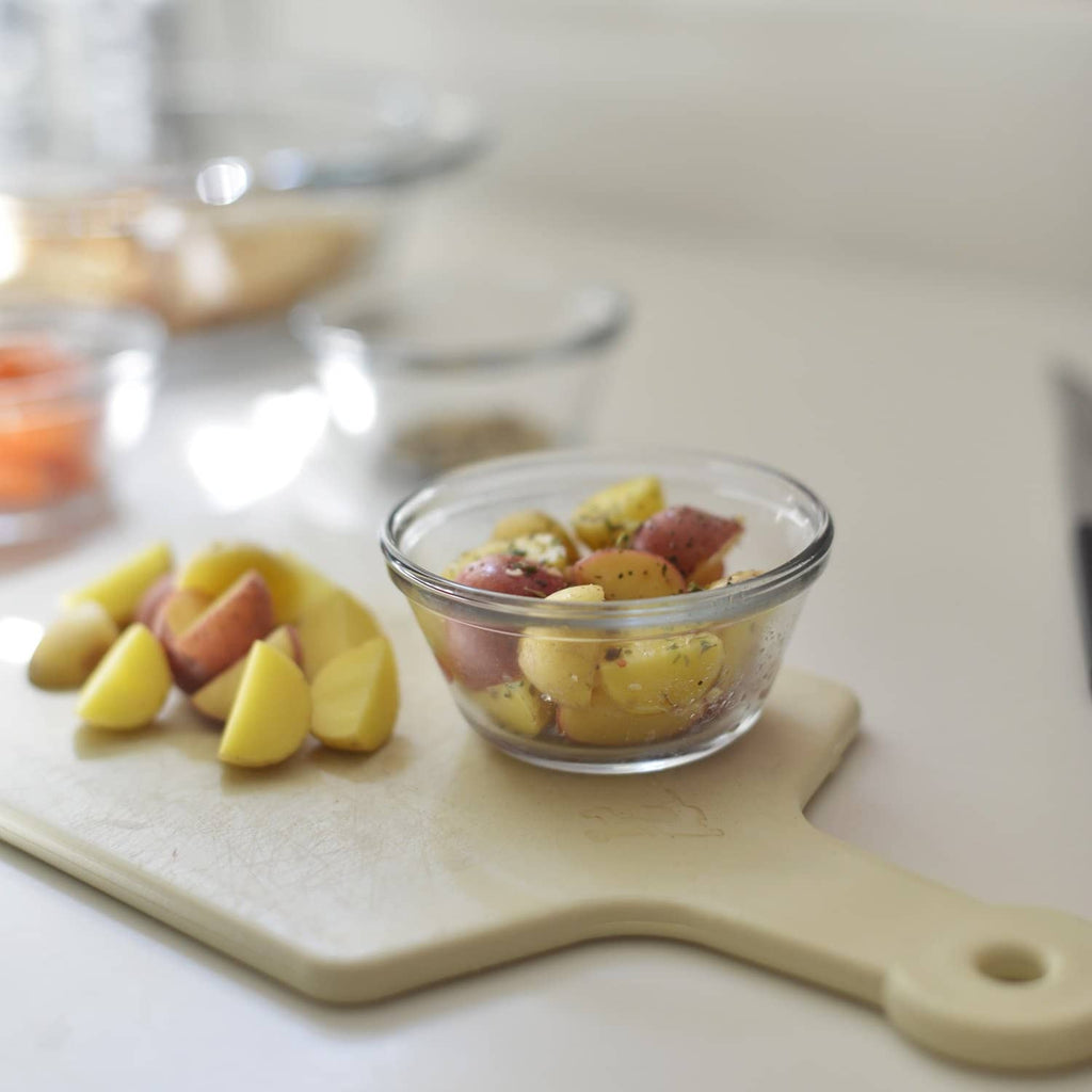 Clear glass custard cup filled with fruit and custard