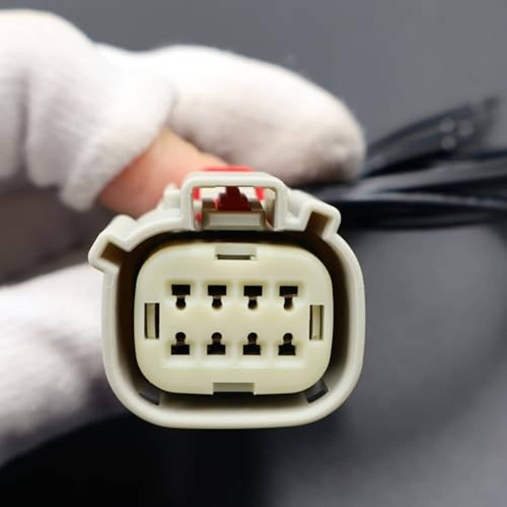 Headlight connector plug interior with pin sockets and red latch