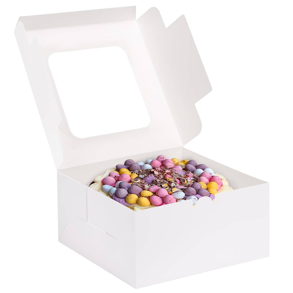 White square bakery cake box with open lid, holding colorful cupcakes inside.