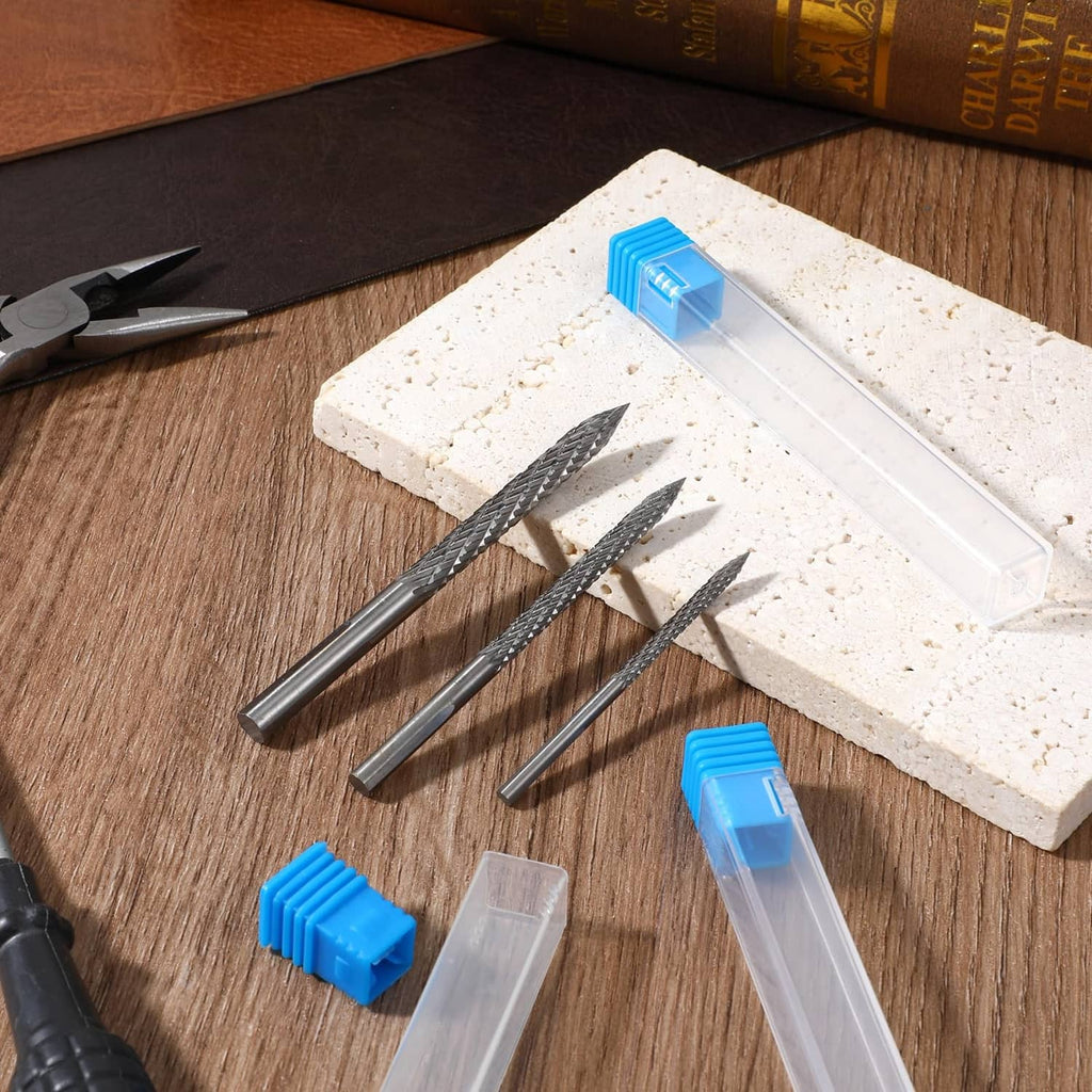 Three tire reamer drill bits with blue caps and clear storage case pieces