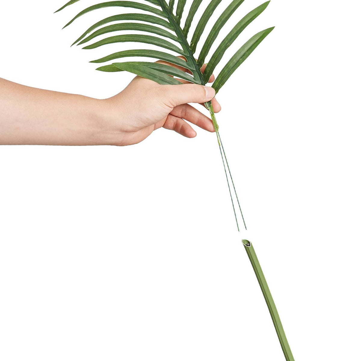 Artificial golden cane palm tree faux plant with green fronds held by hand