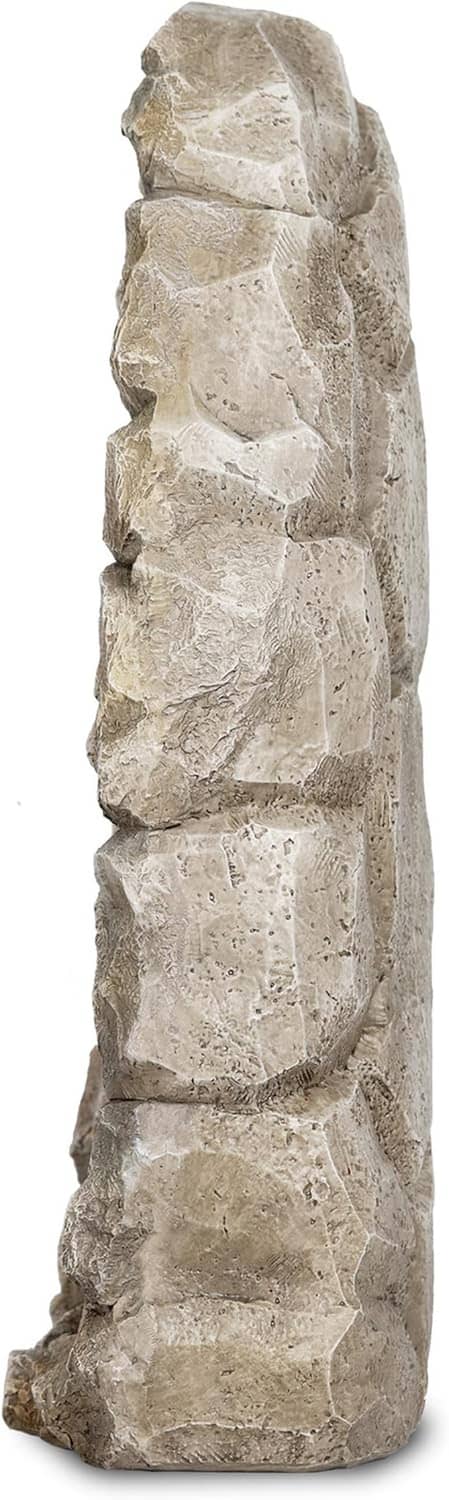 Tall gray stone statue side profile, carved ridges and stacked rock texture.