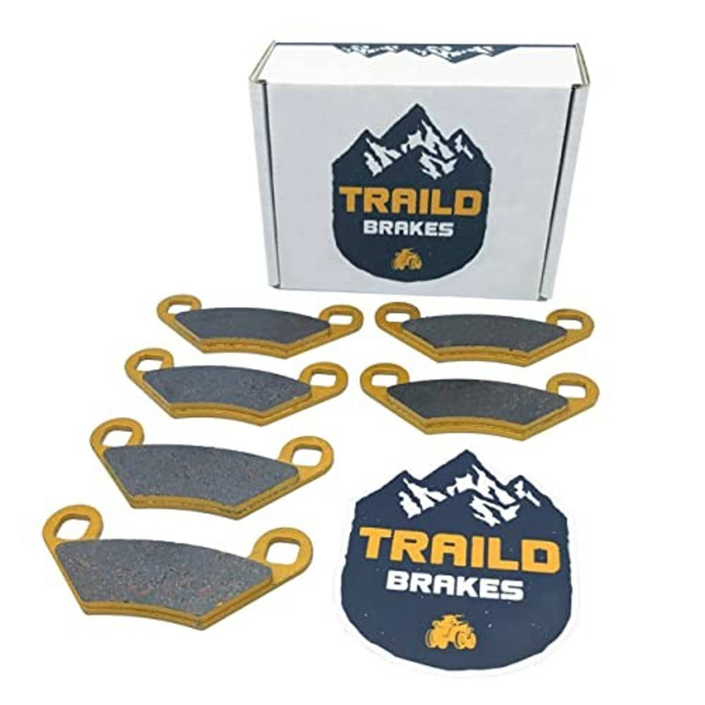 Ceramic brake pads set with dark gray pads, gold edges, and a logo product box