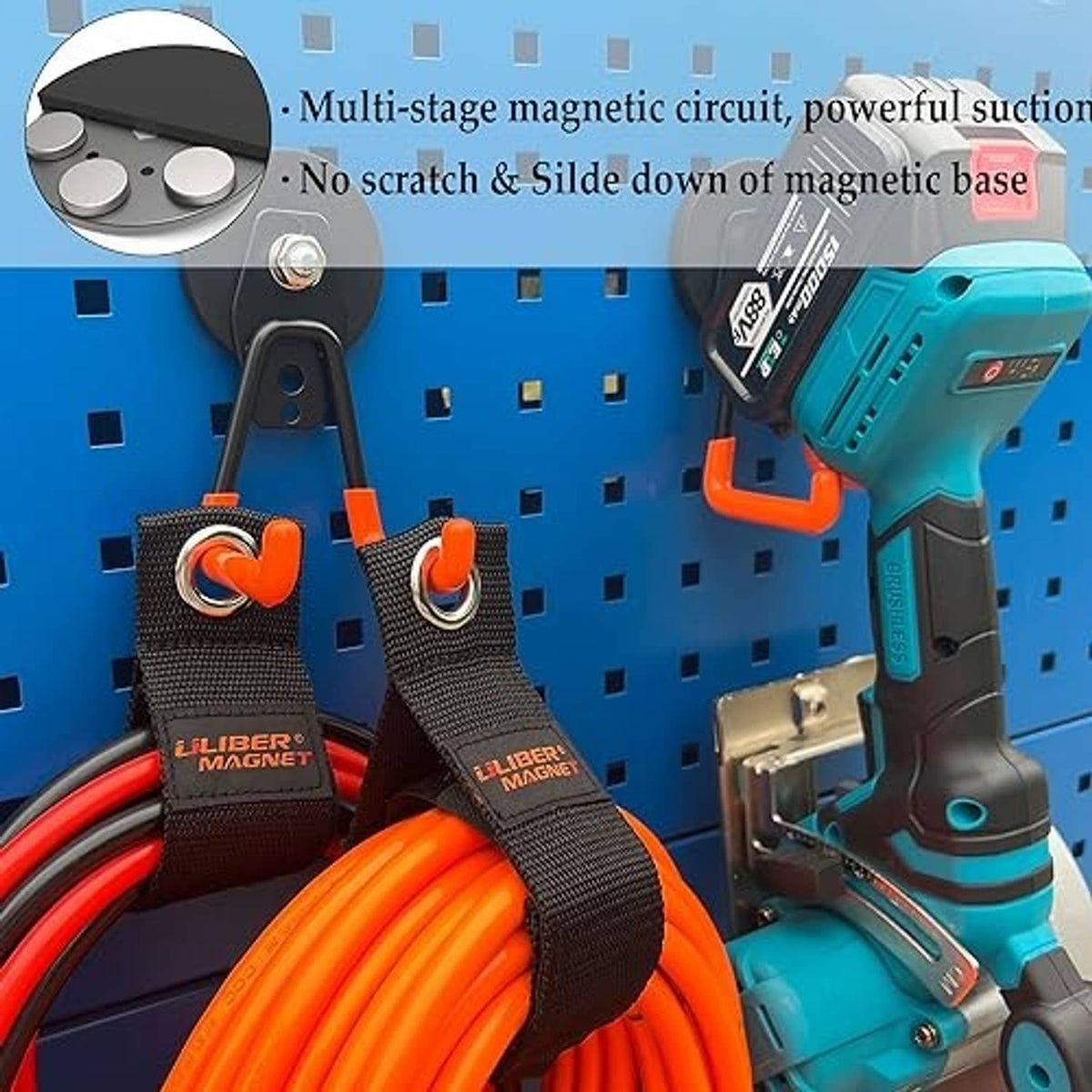 Orange-and-black magnetic hooks on pegboard, holding coiled cords and a power tool