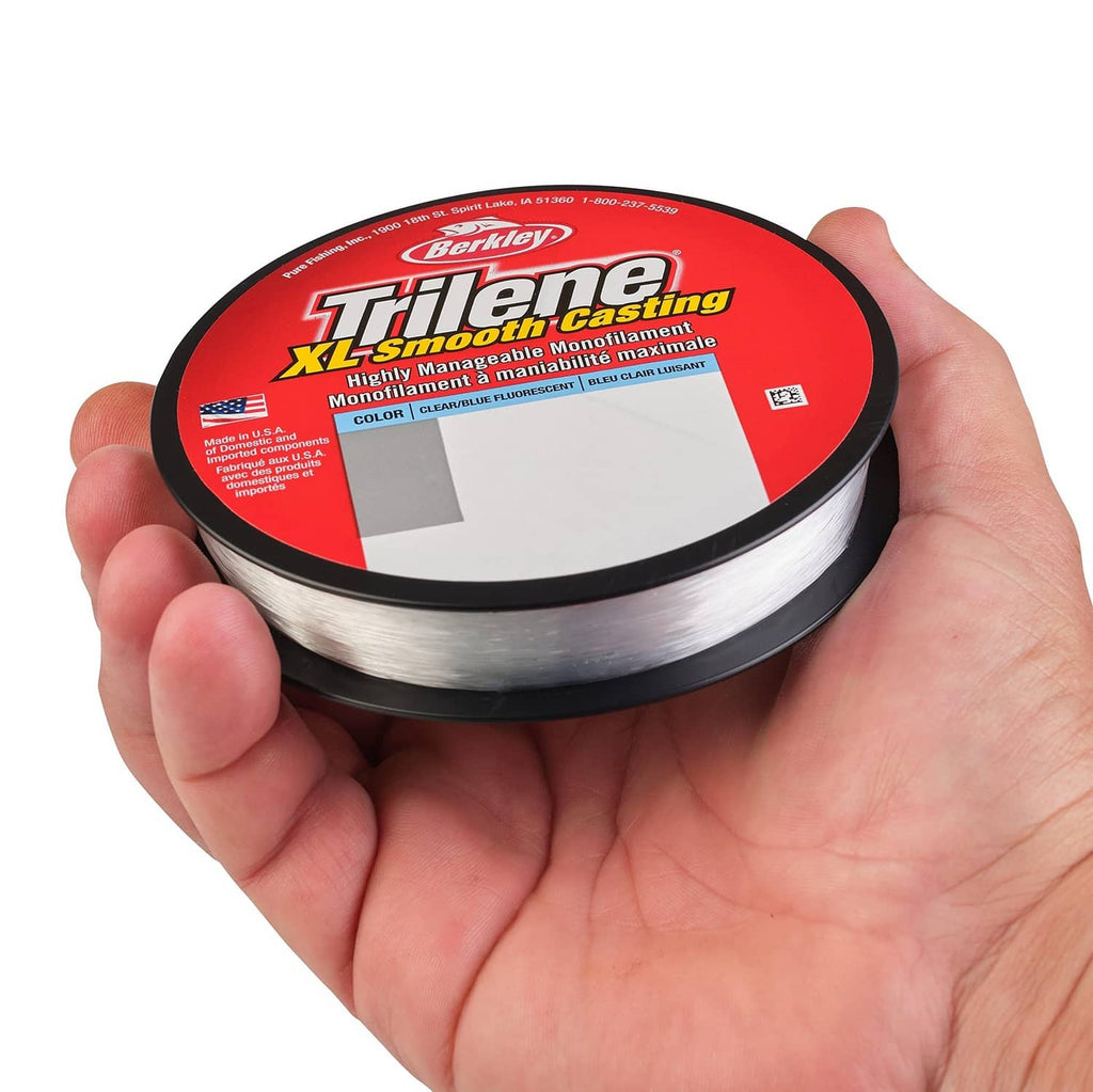 Hand holding Berkley Trilene XL fishing line spool, Clear/Blue fluorescent