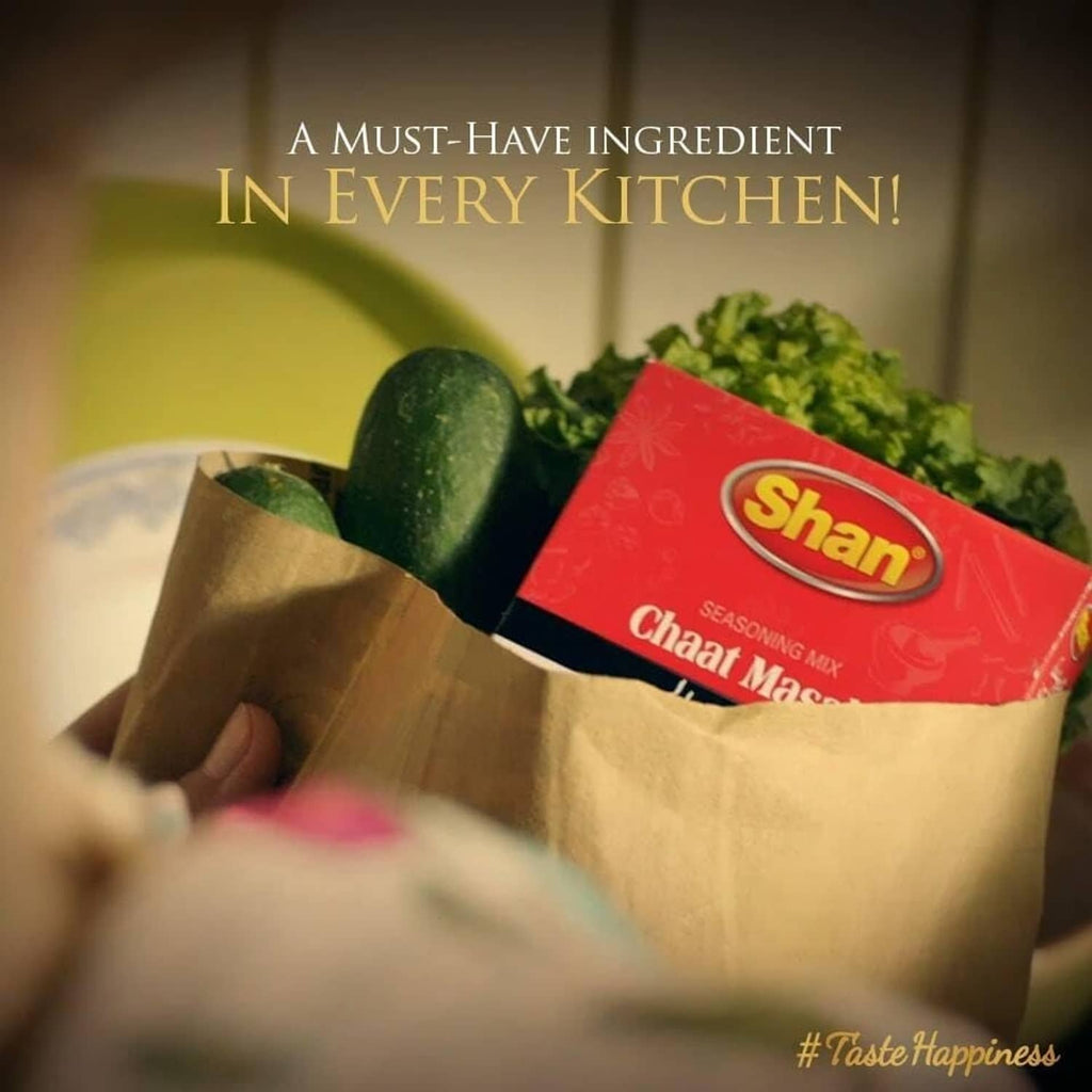 Shan Chaat Masala seasoning mix packet in a paper bag with vegetables promotional