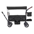 Black double stroller wagon with canopy, side storage bags, and front safety bar.