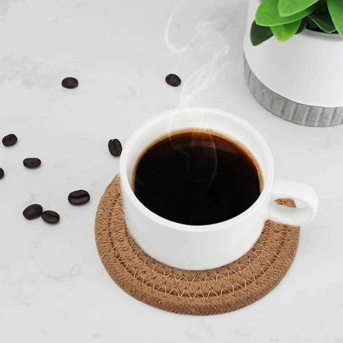 Round woven coaster with a white coffee cup and dark coffee spill, tan braided texture
