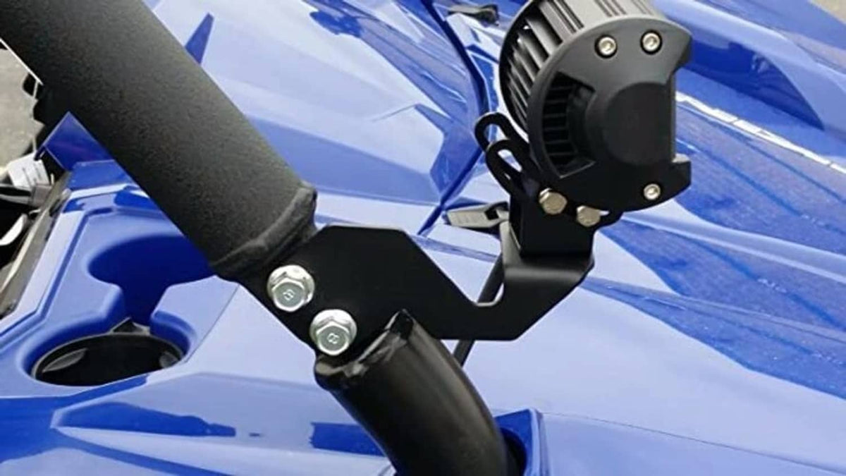 Black A-pillar light mount bracket securing a round LED light to a roll bar