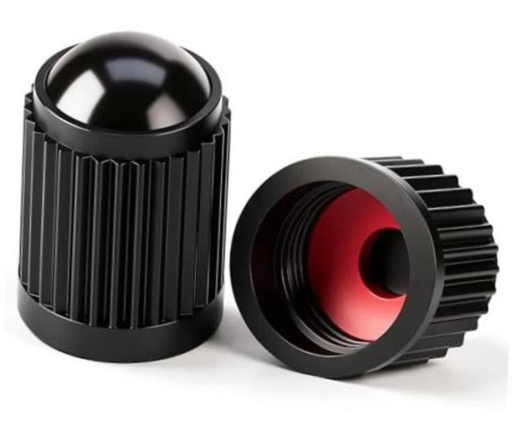 Set of black ribbed plastic tire valve stem caps with red O-ring inserts