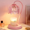 Pink flower-shaped candle warmer lamp with curved handle and clear glass shade