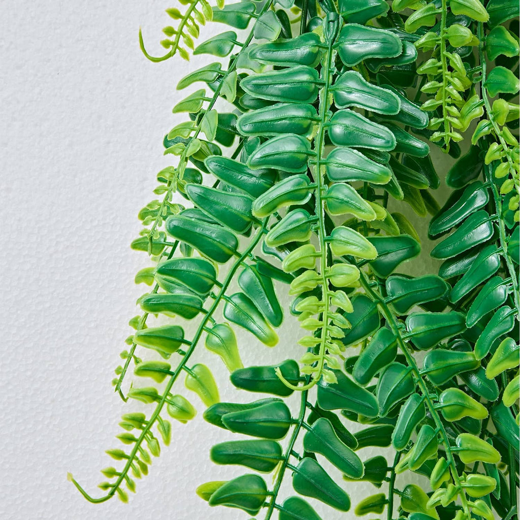 Close-up of artificial Boston fern leaves in glossy green