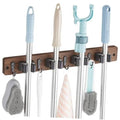 Wall-mounted mop and broom holder with wooden rail, chrome grips, and four hooks