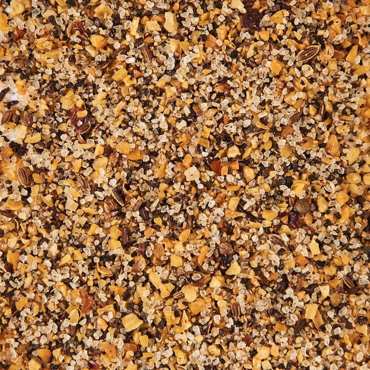 Montreal steak grill seasoning, coarse tan and dark spice mix close-up