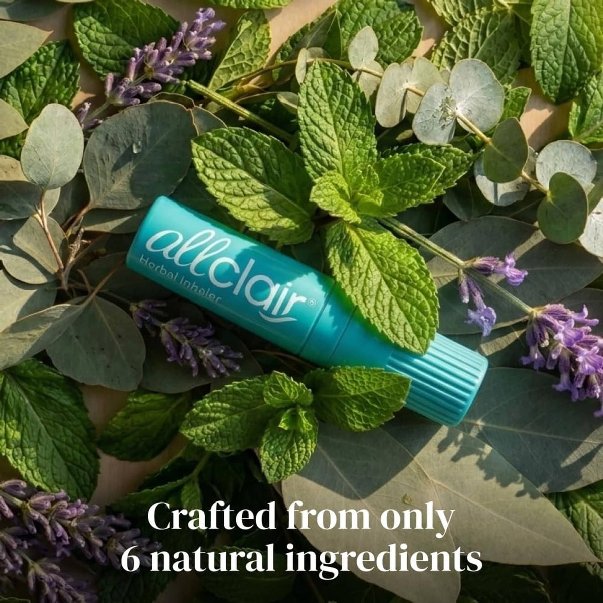 Turquoise herbal inhaler stick nestled among green leaves and small purple flowers