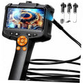 Handheld borescope camera with color screen, orange control dial, and probe attachments