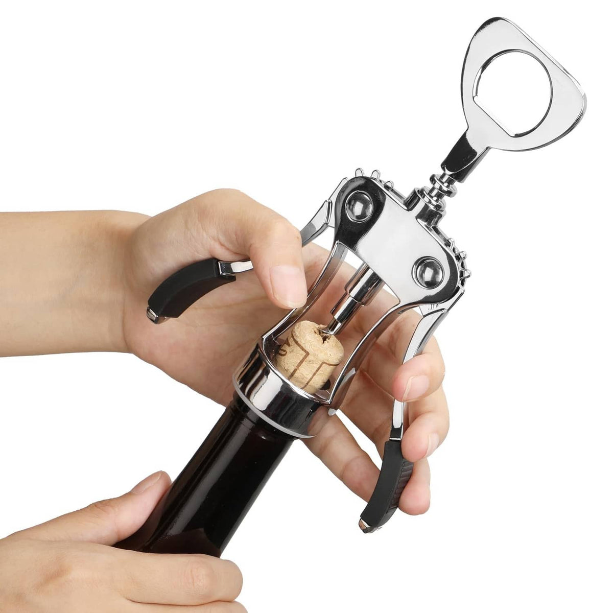 Hands holding a silver wing corkscrew wine opener extracting a cork