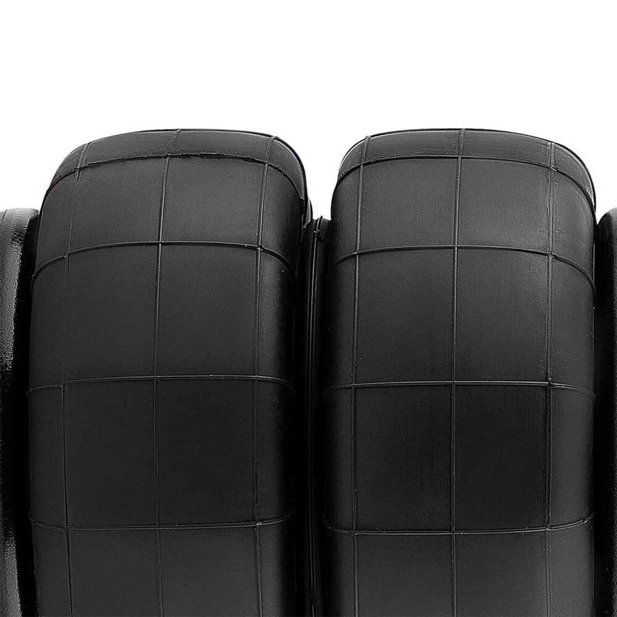 Close-up of two black air suspension bellows with seam lines and molded panels