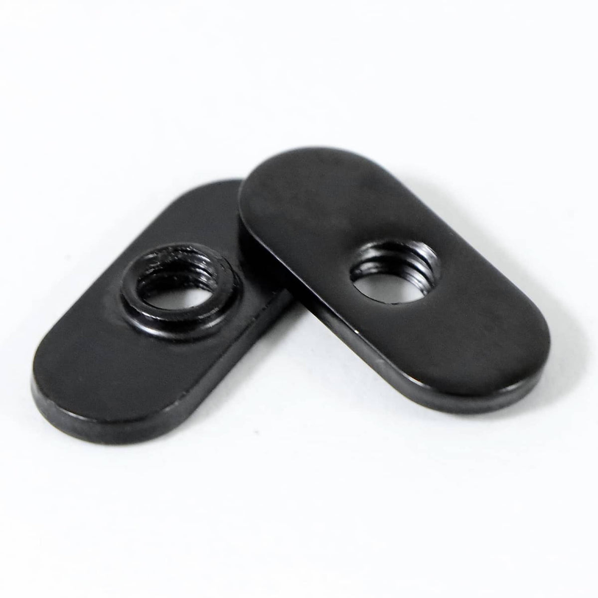Black 1/4-20 centered slide T-nut pair, threaded holes visible