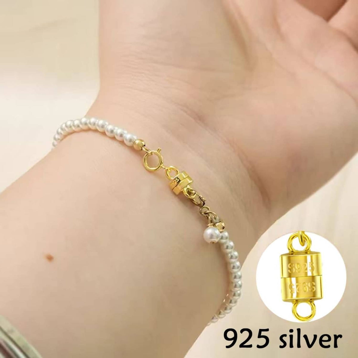 Pearl bracelet with gold-tone magnetic clasp extender on wrist, with close-up of the lock