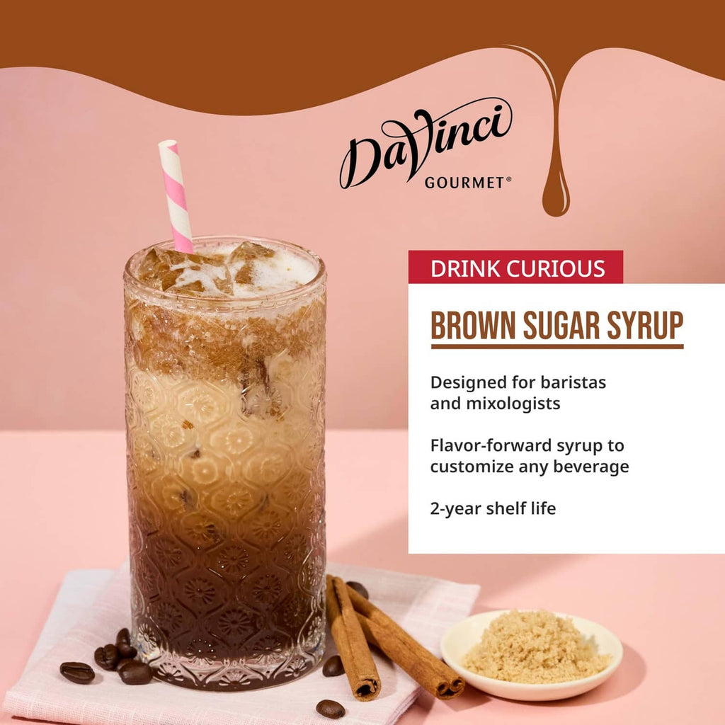 Iced brown sugar syrup drink with straw, cinnamon sticks, and brown sugar