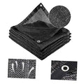 Black shade cloth roll folds with metal grommets for outdoor sun protection