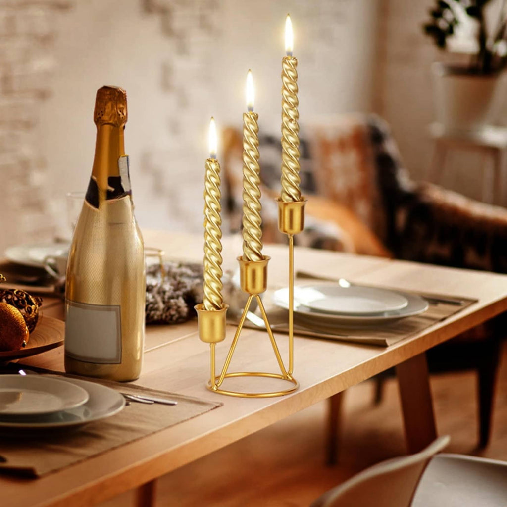 Gold three-candle iron stand with twisted candle stems and three cup holders
