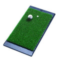 Green turf hitting mat with dark weighted rubber base, golf ball and tee targets