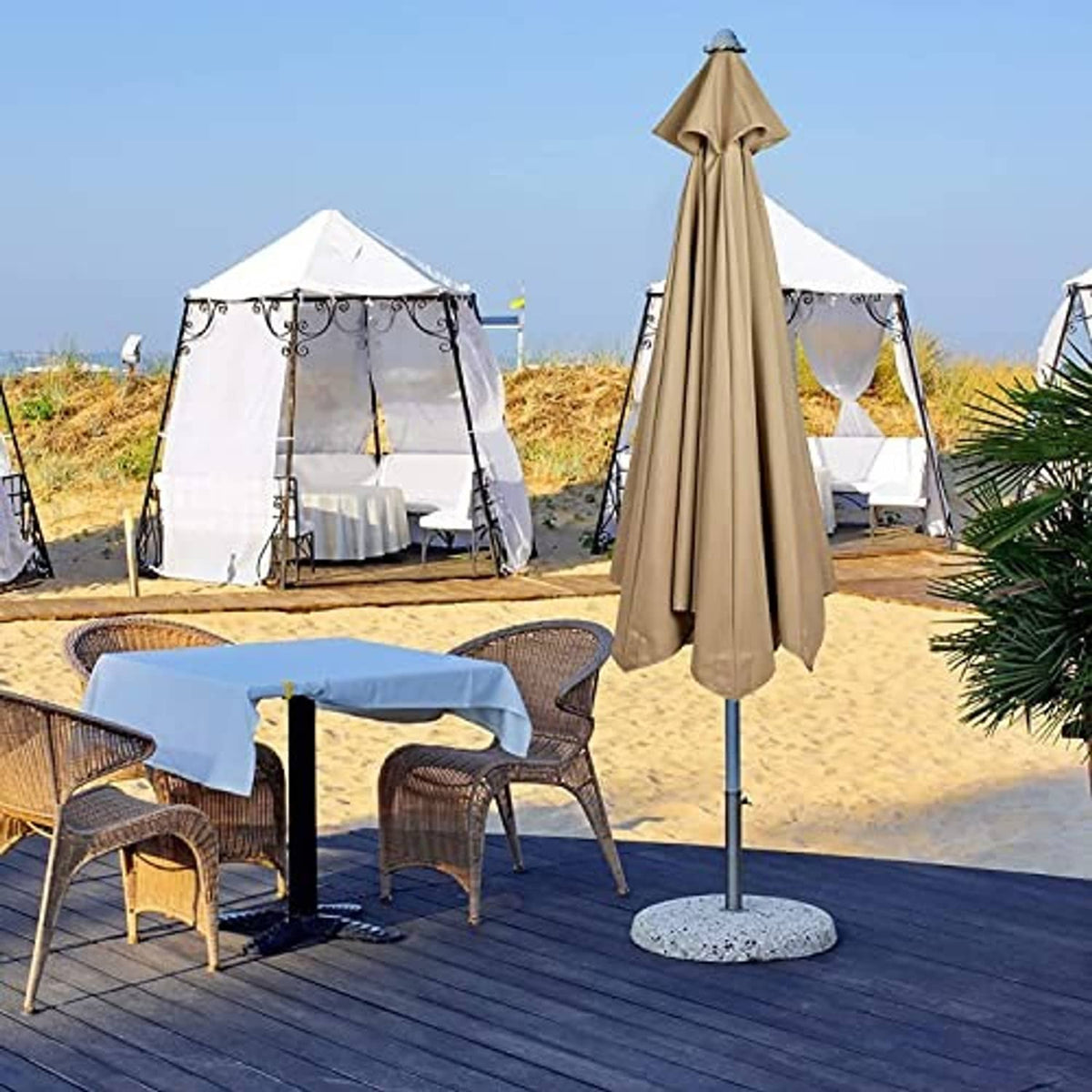 Tan market umbrella canopy replacement standing on pole with fabric cover